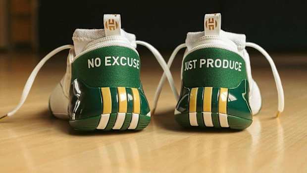 Rear view of James Harden's green and gold adidas shoes.